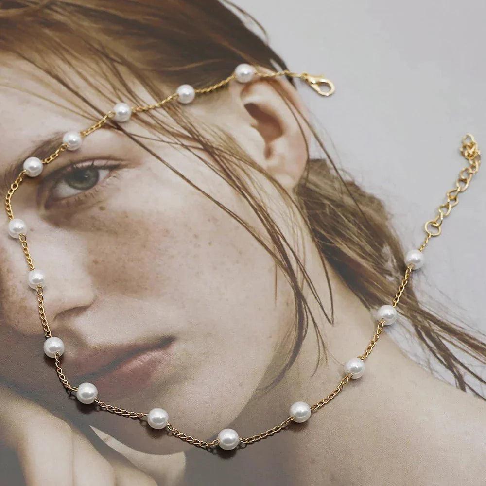 Gold chain with pearls around a woman&
