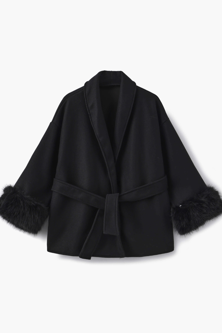 Black coat with fur trim on a white background