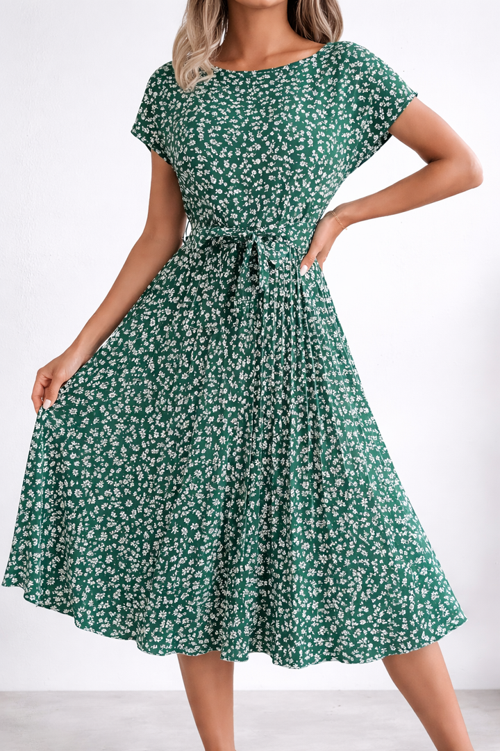 Green floral dress worn by a model on a white background