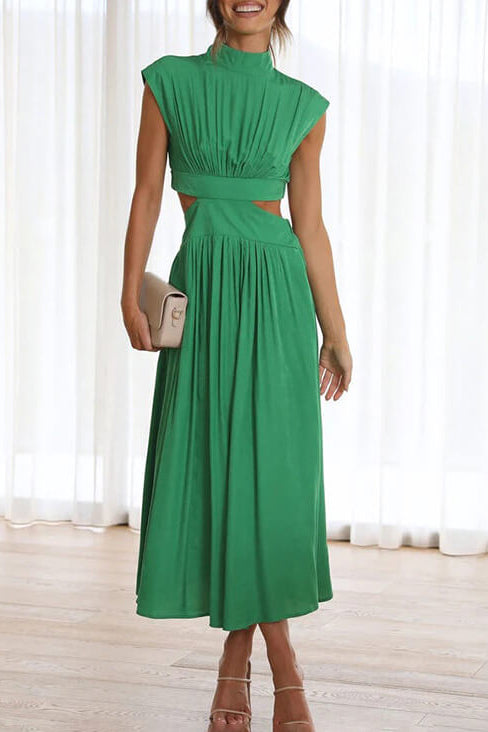 Woman wearing a green dress with a white curtain background