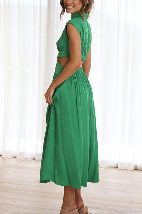 Woman wearing a green dress with a white curtain background